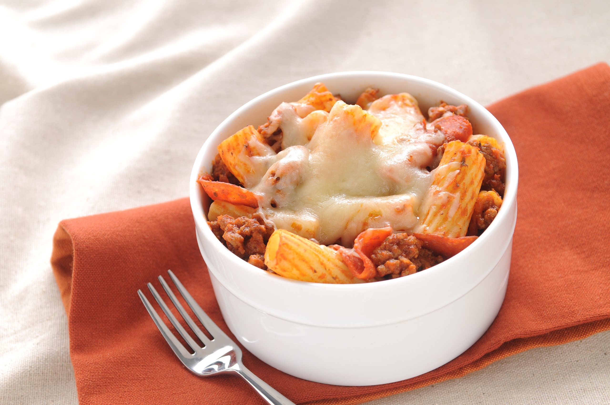 Pizza pasta with rigatoni, Italian sausage, pepperoni, sauce and cheese