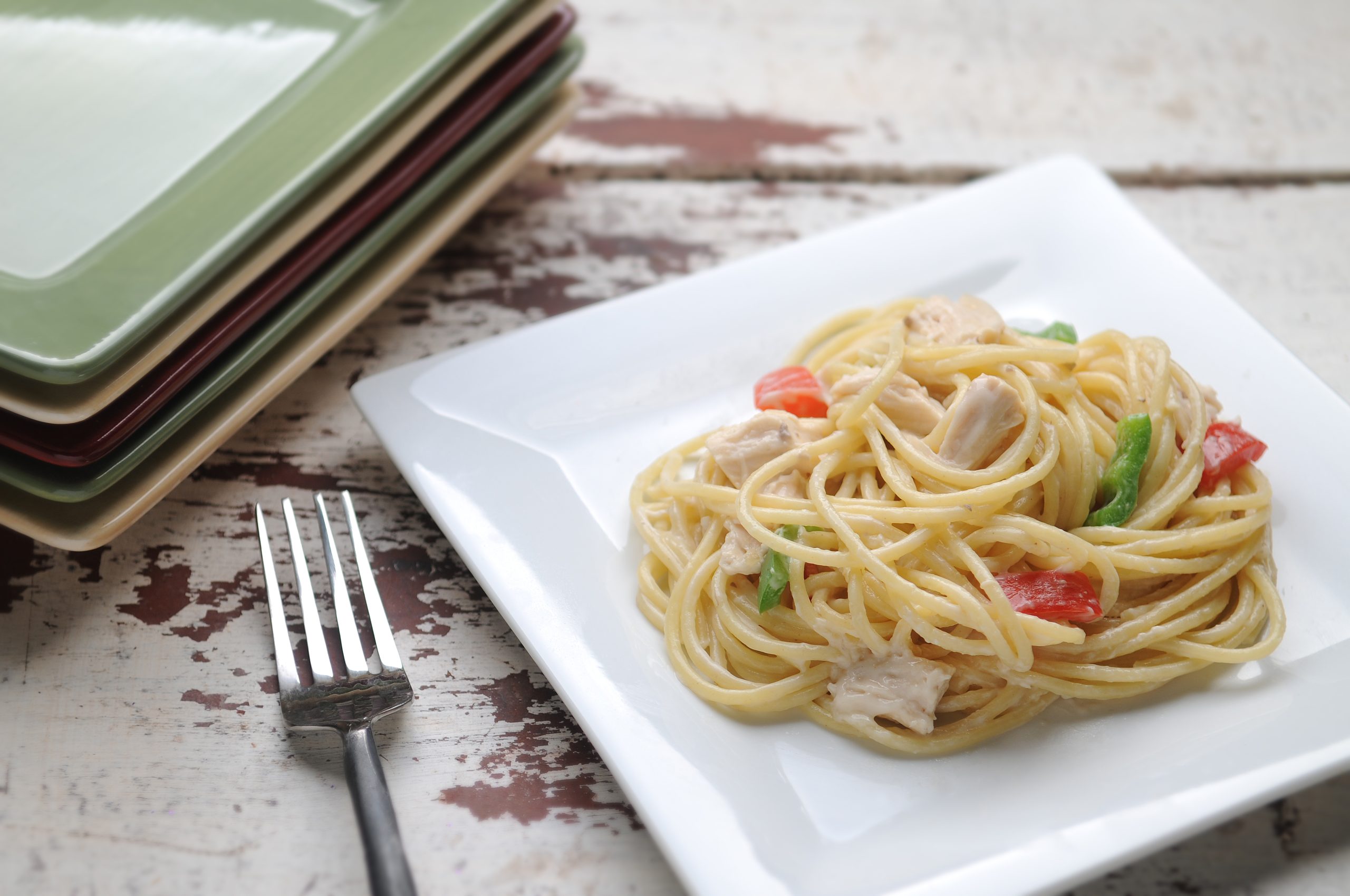Peppers, chicken, and spaghetti coated in a creamy sauce
