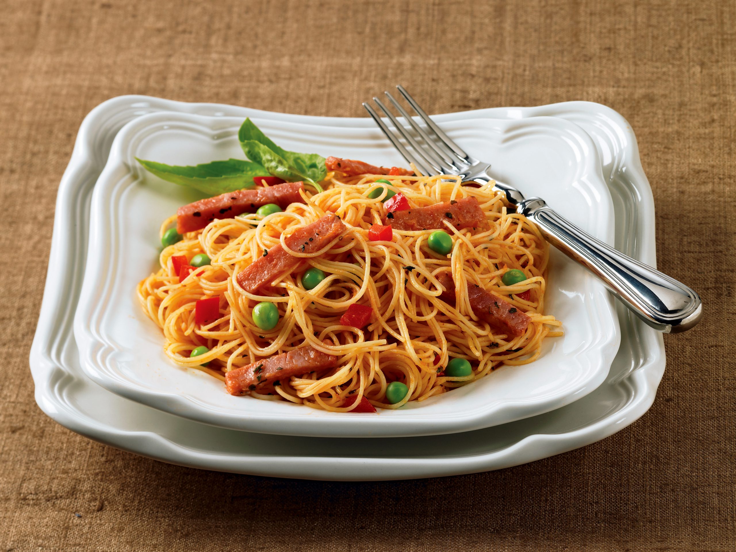 Angel hair pasta with ham and fresh vegetables in a light sauce