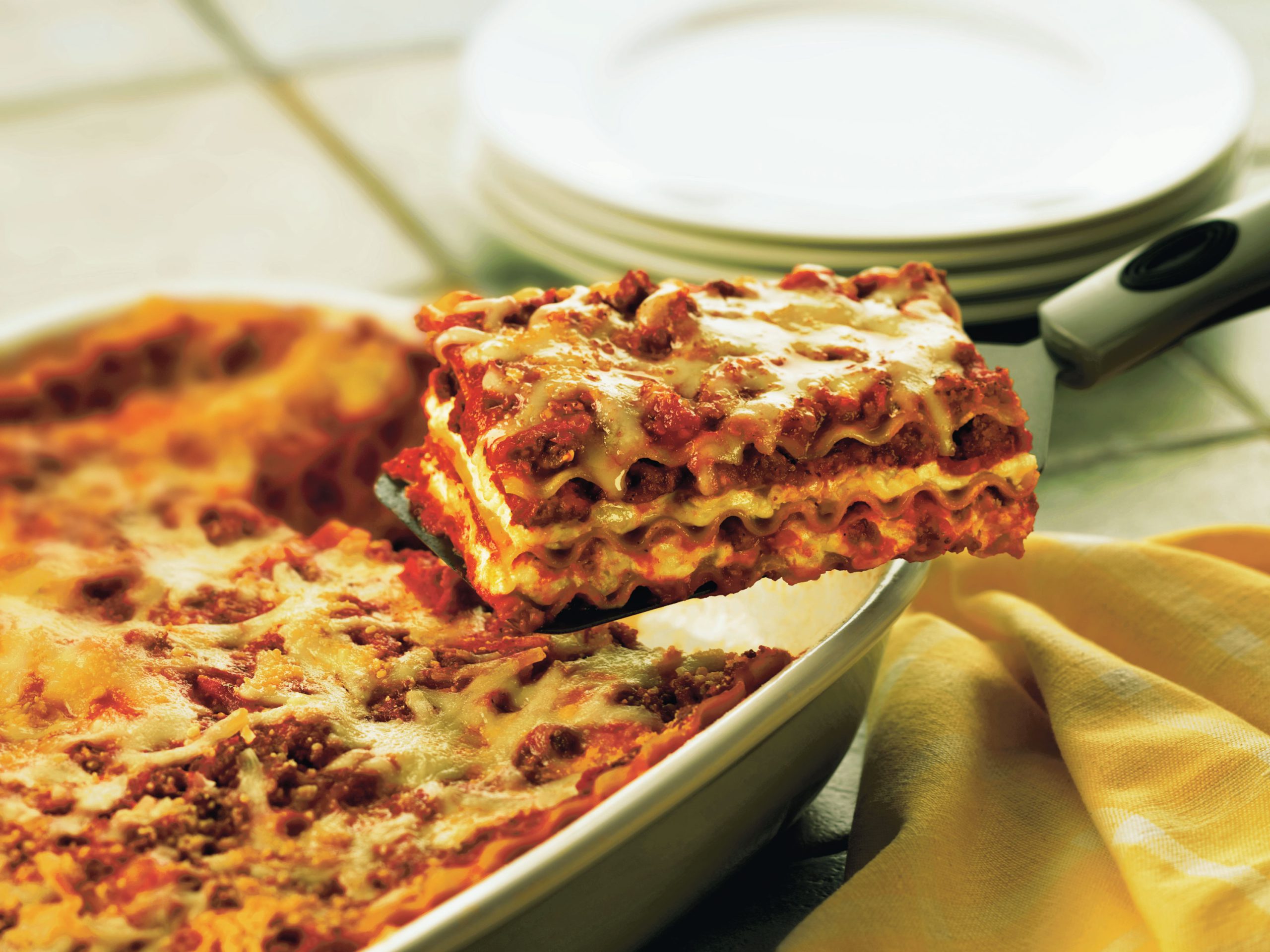 Classic sausage lasagna with layers of noodles, tomato sauce, Italian sausage, and cheese