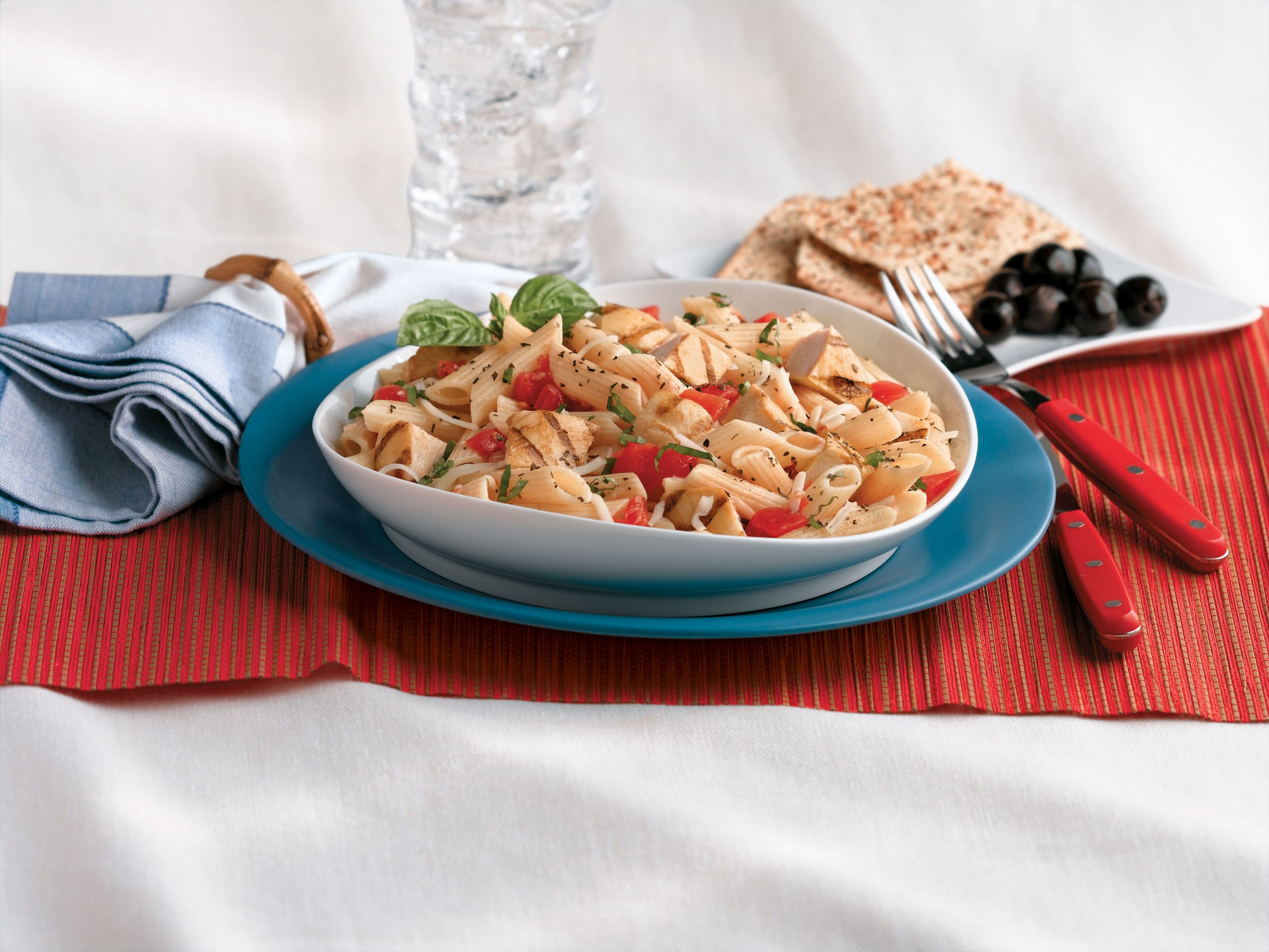 Penne with grilled chicken and caprese flavors of mozzarella, fresh basil, and diced tomatoes