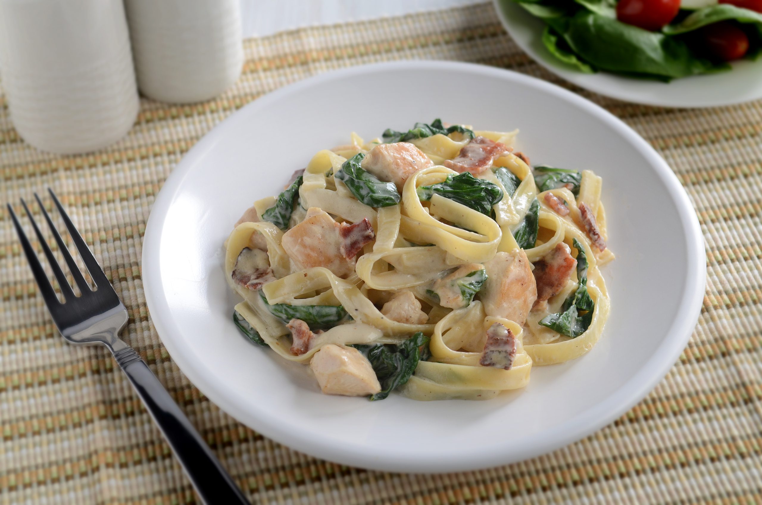 Linguine with bacon, Alfredo sauce, diced chicken, fresh spinach, and Parmesan cheese