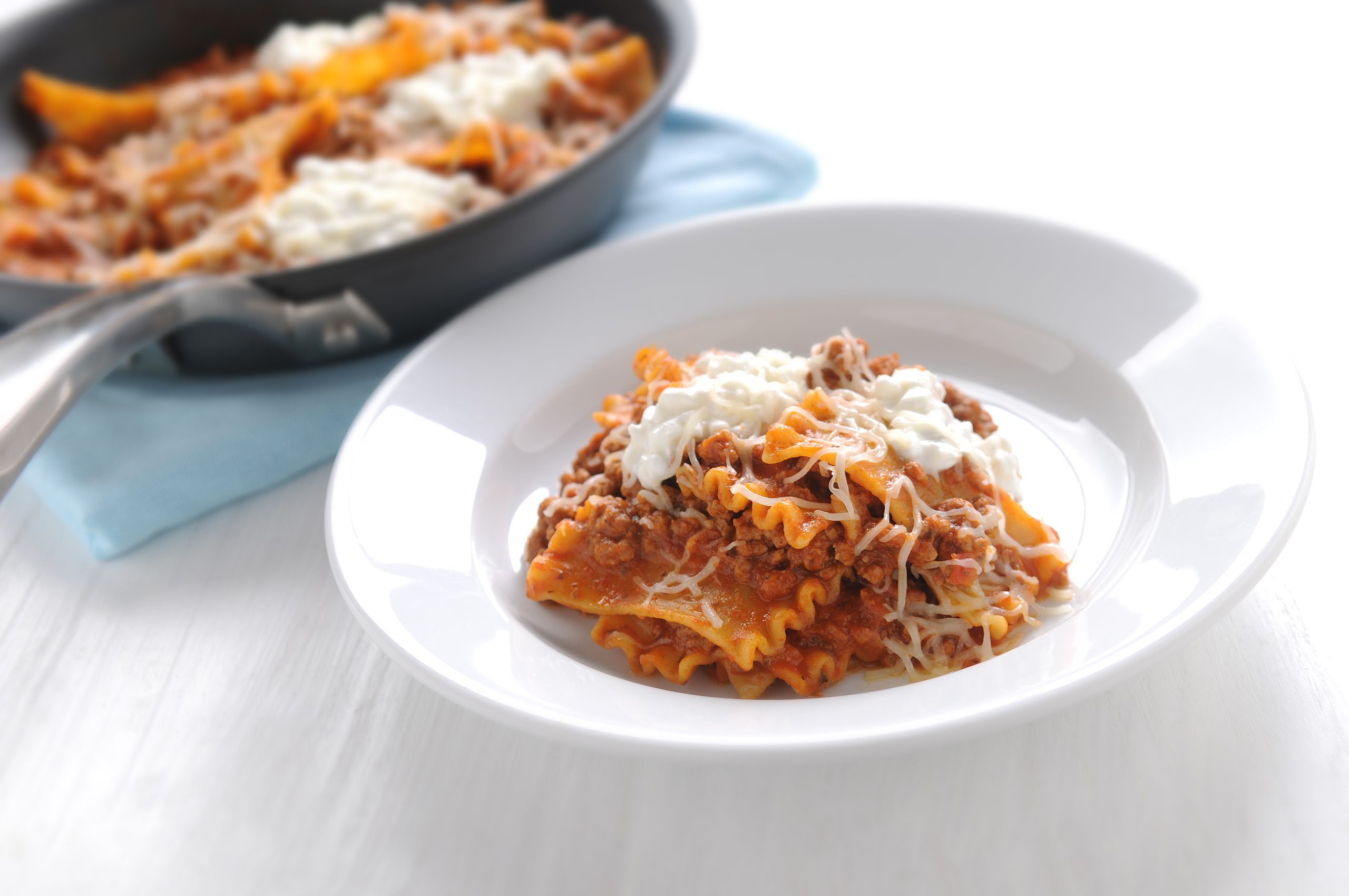 Italian skillet lasagna with ground beef, pasta sauce, ricotta, and Italian shredded cheese