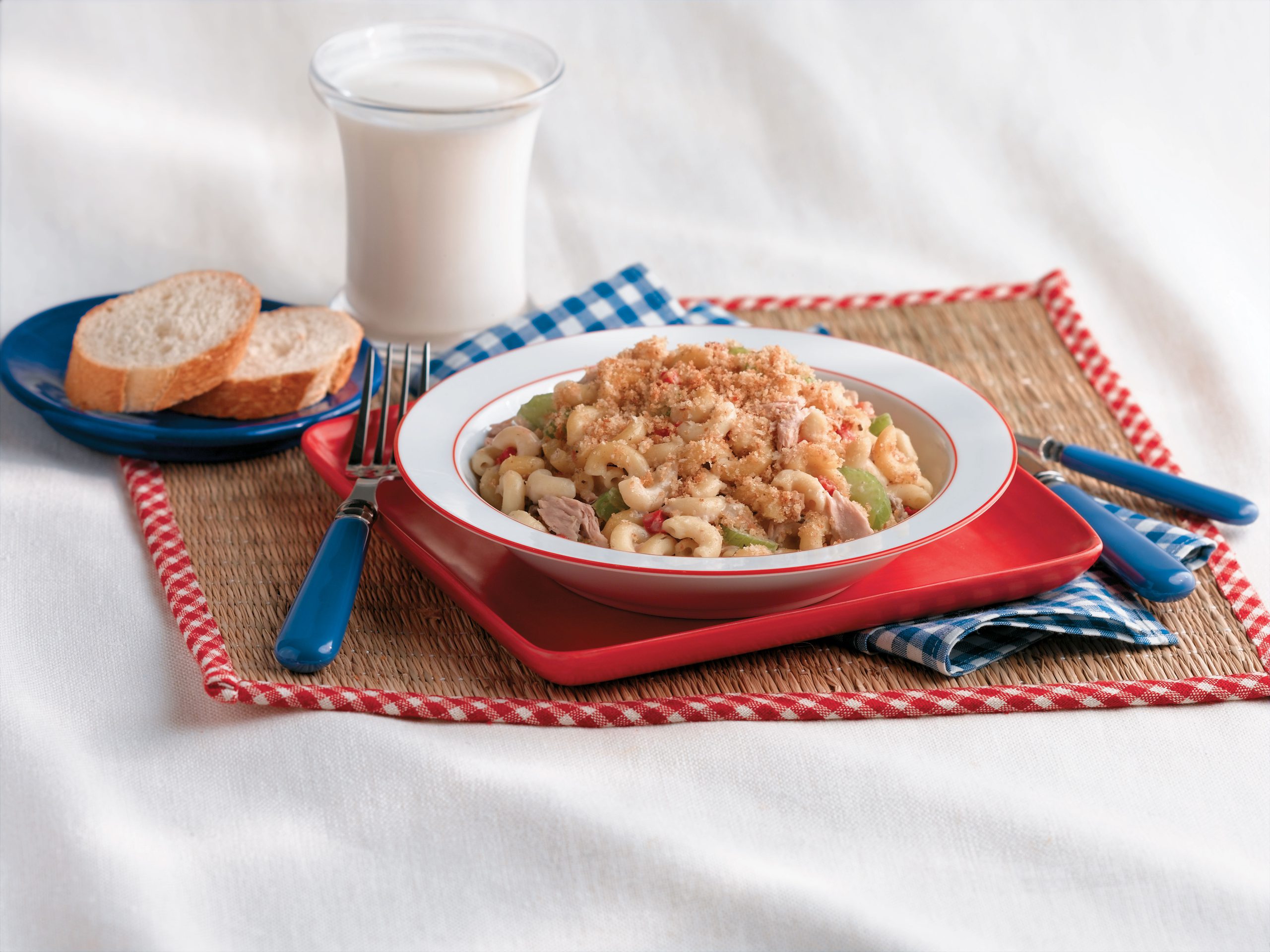 Picnic macaroni salad with elbows, celery, and green peppers, topped with bread crumbs