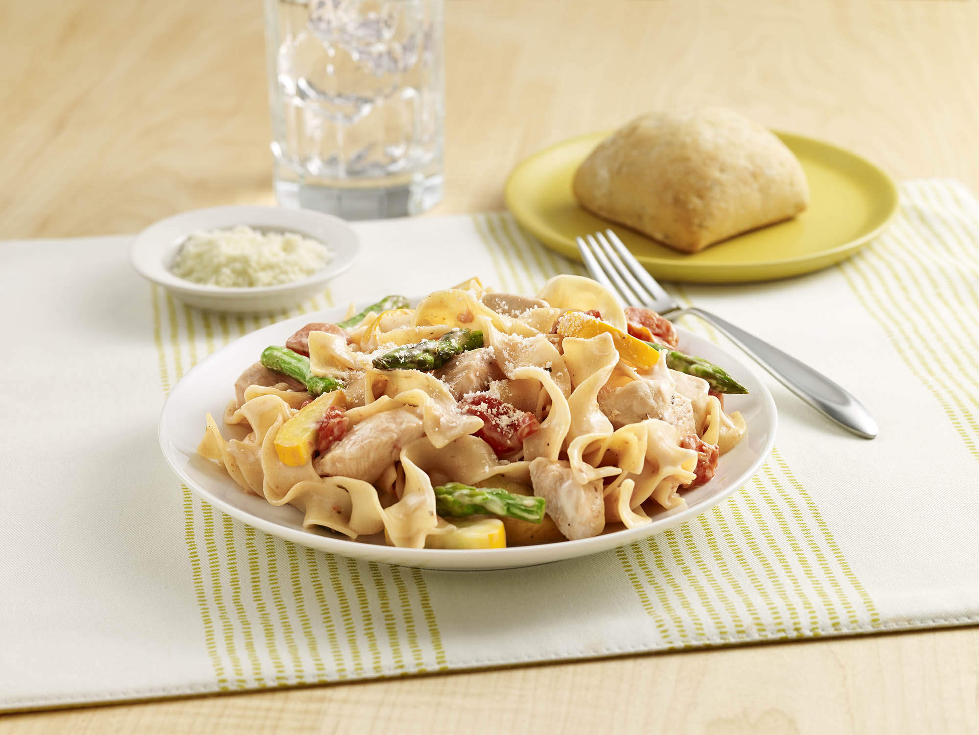 Chicken Noodle Primavera An egg noodle recipe with chicken, fresh vegetables, seasoned tomatoes and Alfredo sauce.